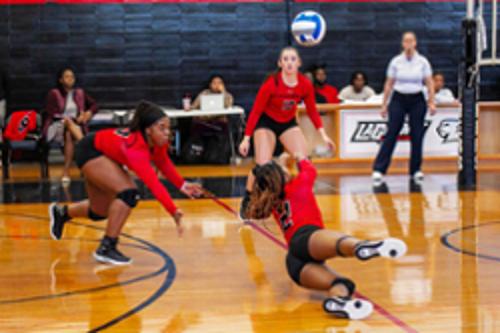 Women play volleyball